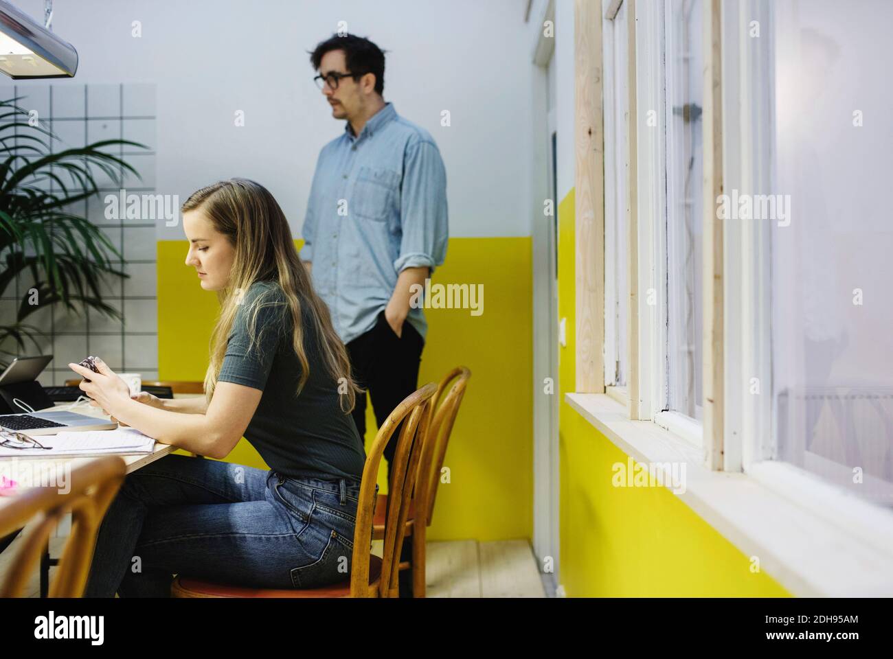 Woman crossed legs standing office hi-res stock photography and images ...