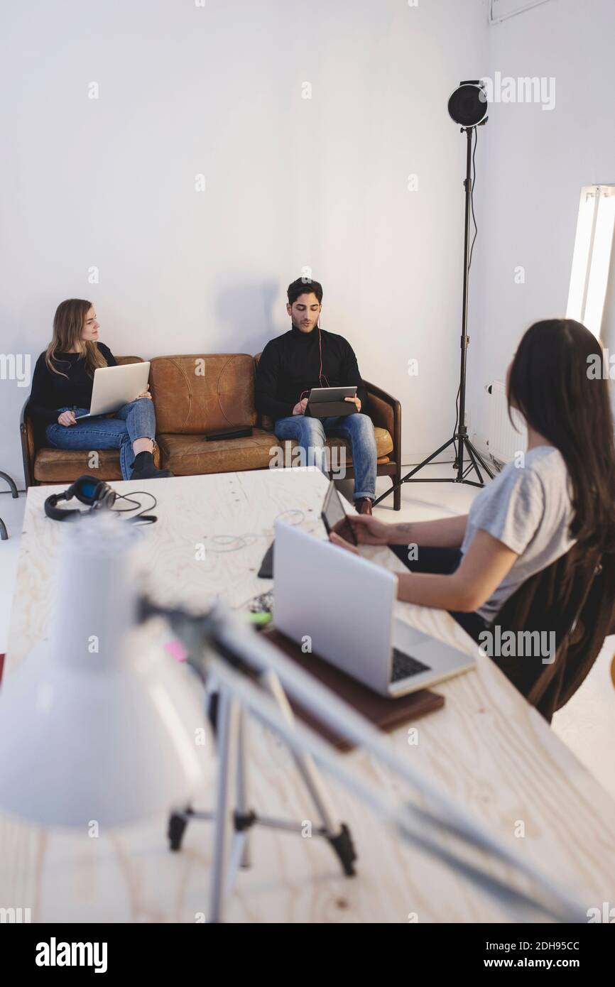 Three colleagues discussing in creative office Stock Photo