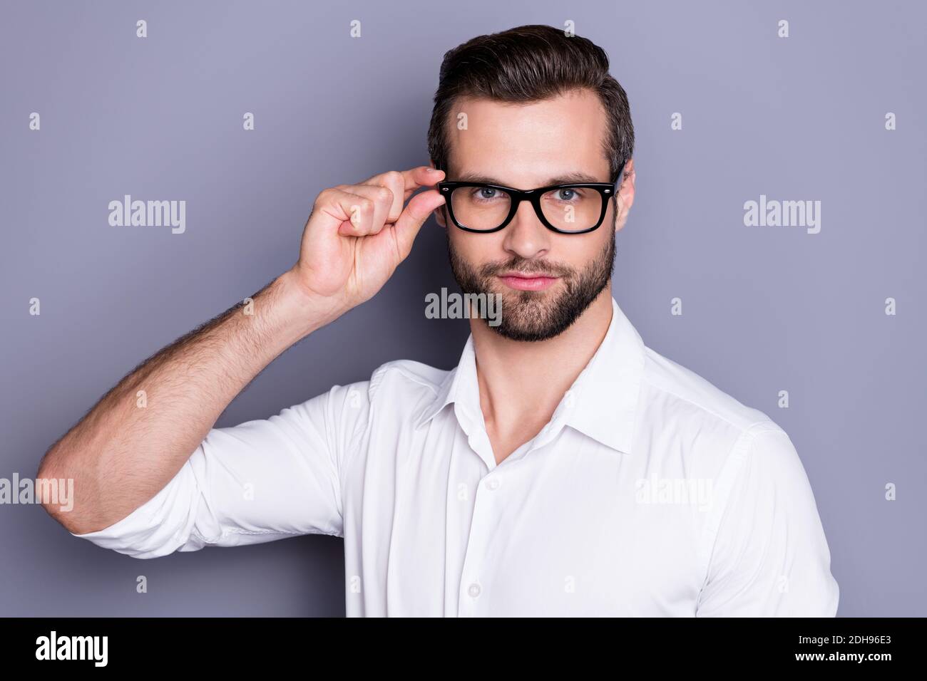 Close-up portrait of his he nice attractive successful content serious professional man ceo boss chief wearing touching specs focus isolated over grey Stock Photo
