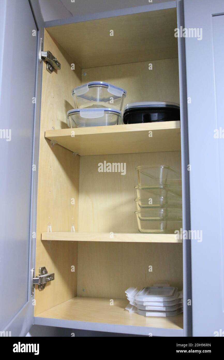 organized glass food storage containers in cupboard Stock Photo Alamy