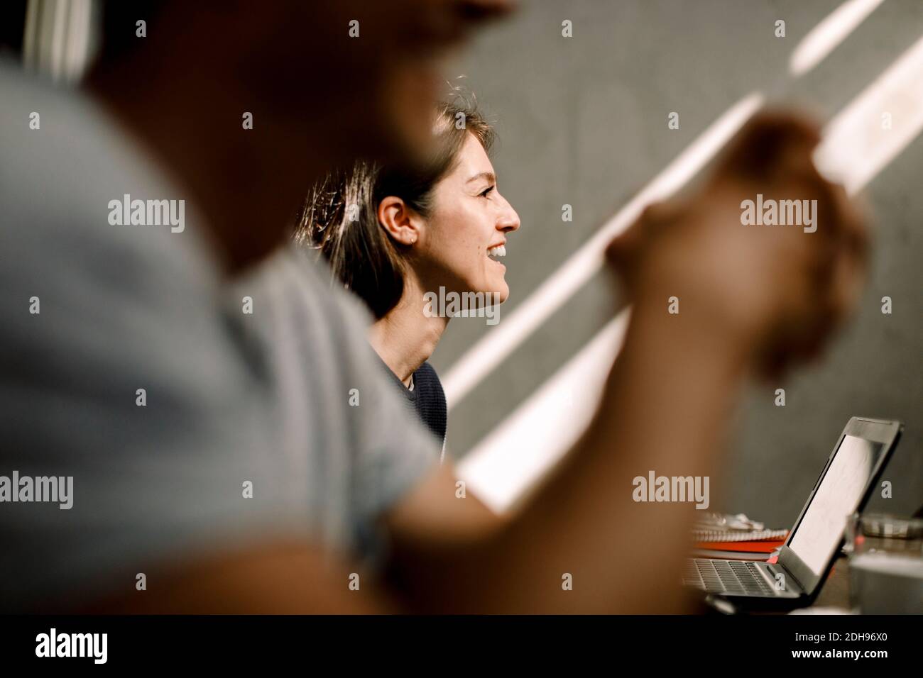 Smiling businesswoman sitting in office Stock Photo