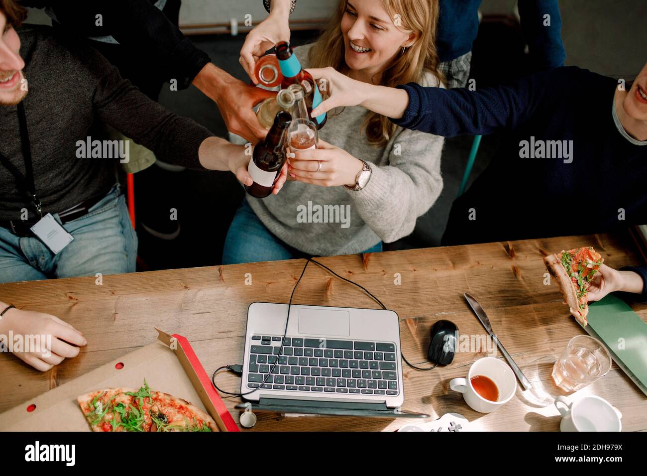 Smiling professionals toasting drinks in office Stock Photo Alamy