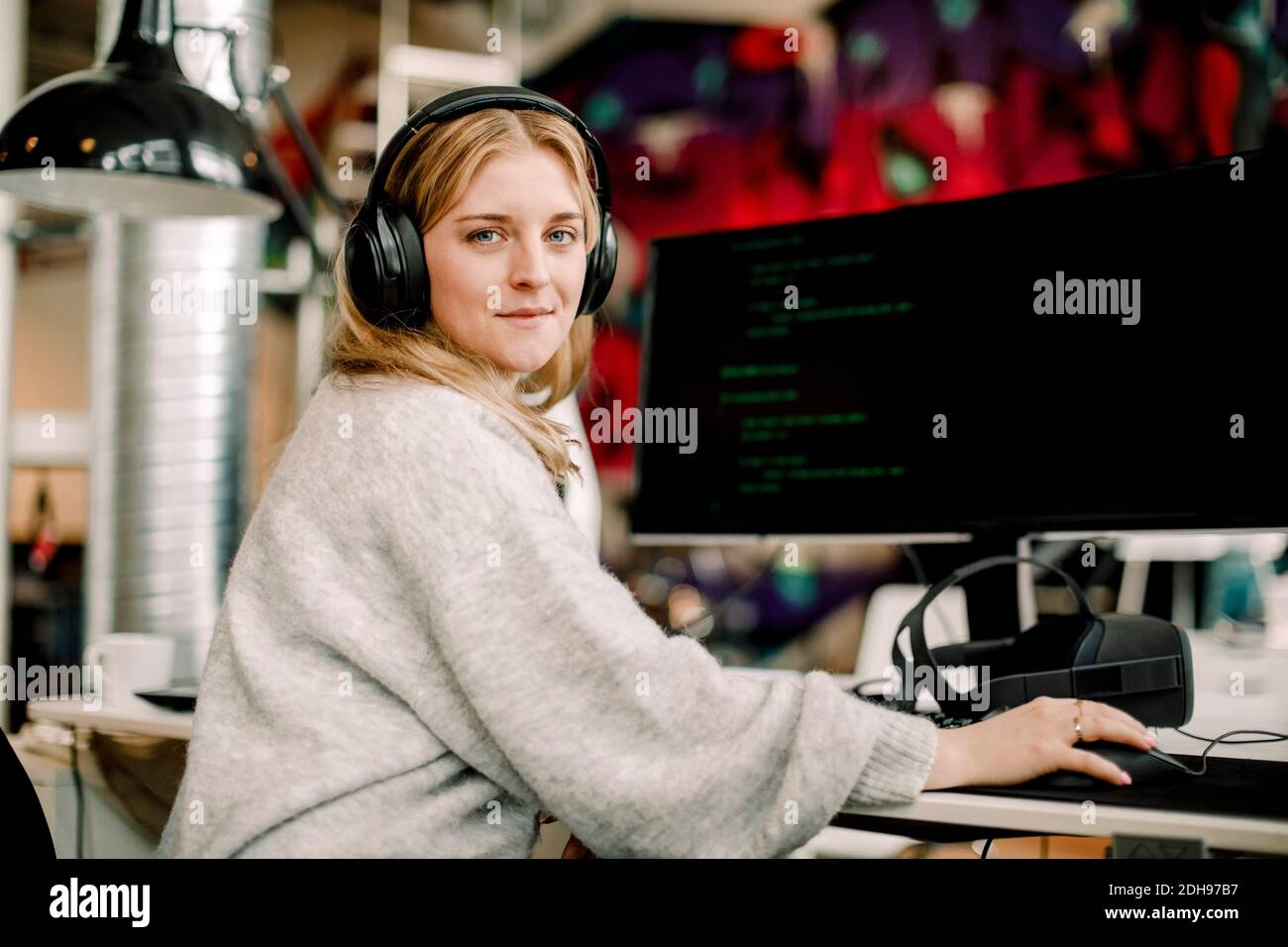 Portrait of female computer programmer sitting in office Stock Photo