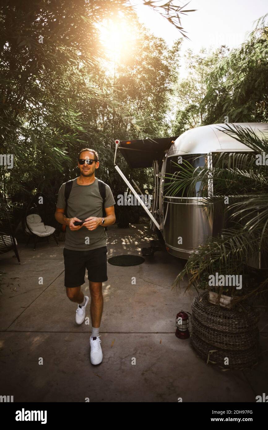 Smiling man walking outdoors Stock Photo Alamy