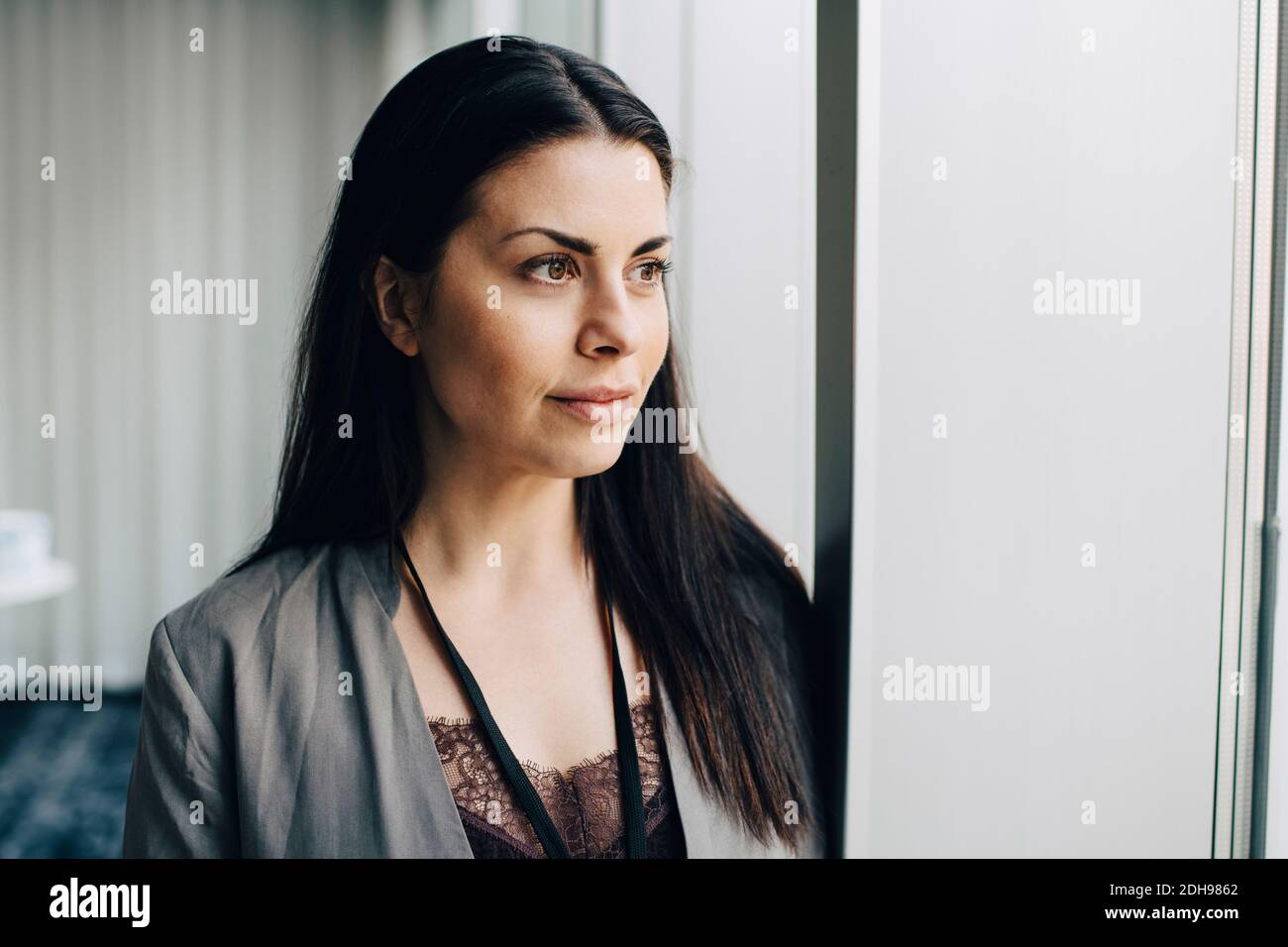 Businesswoman looking away at workplace Stock Photo