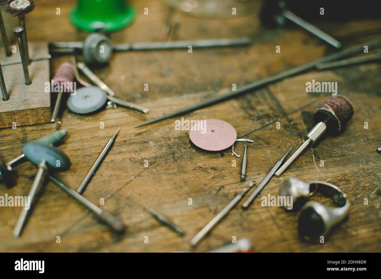 High angle view of jewelry making tools on workbench in workshop Stock Photo