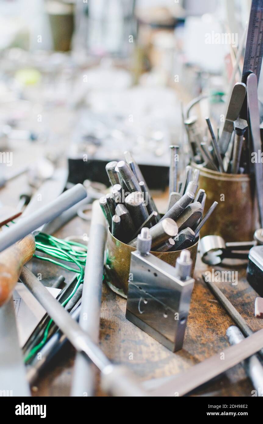 High angle view of various tools in container on workbench at jewelry workshop Stock Photo