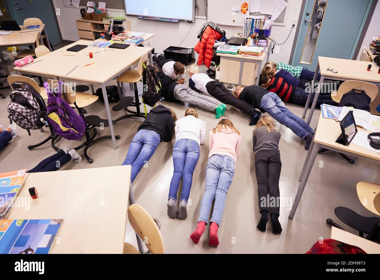 High angle view of junior high students in plank position at classroom Stock Photo