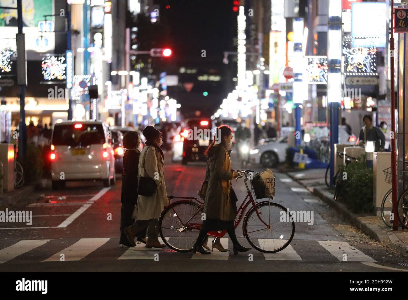 Nagoya, Japan. 10th Dec, 2020. People wearing face masks walk on a street in Nagoya, Japan, on Dec. 10, 2020. On Wednesday, Japan confirmed over 2,810 daily virus cases as the nation struggles to contain the latest surge in infections. Credit: Du Xiaoyi/Xinhua/Alamy Live News Stock Photo