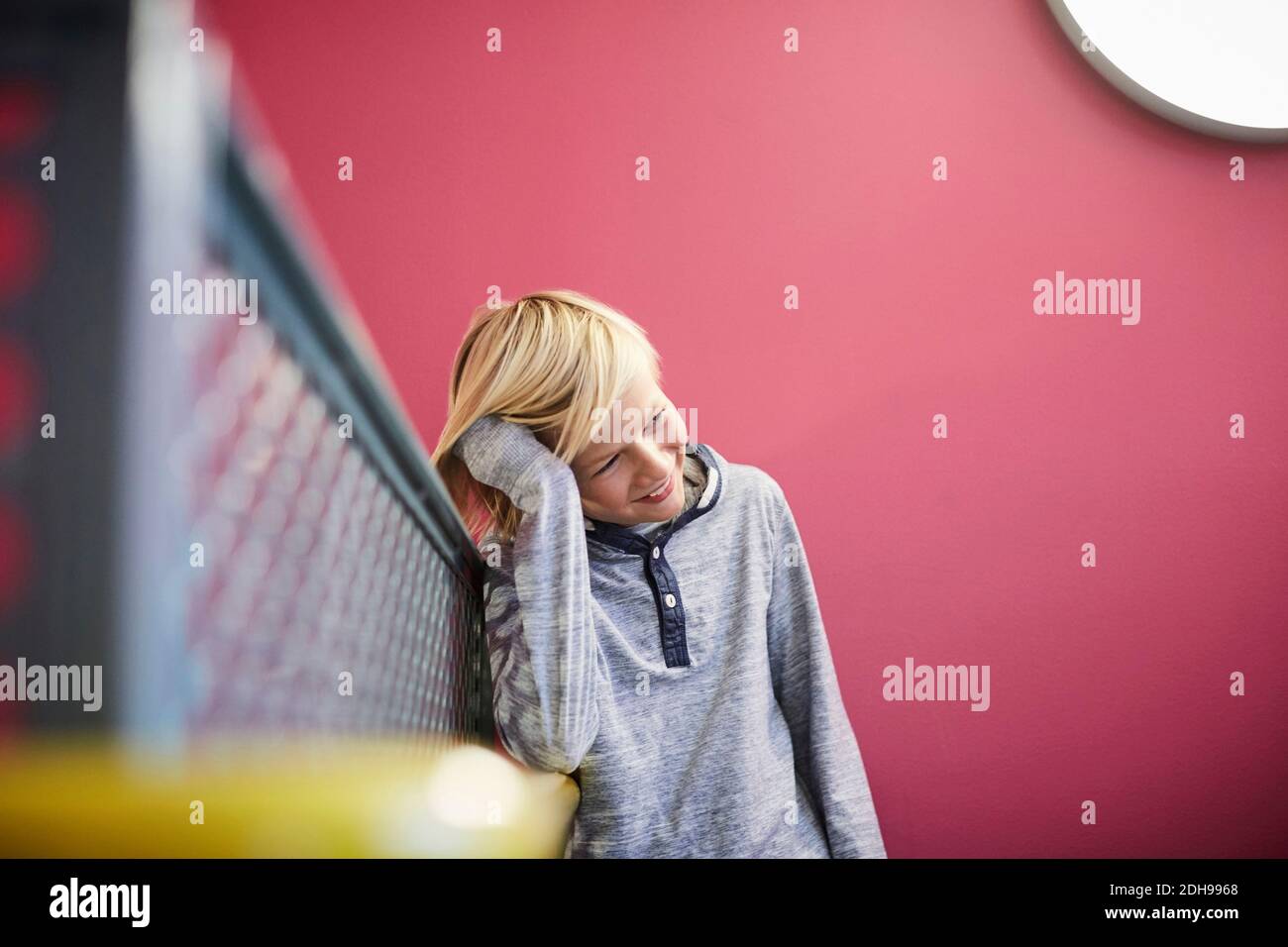 Thoughtful boy leaning on railing at middle school Stock Photo