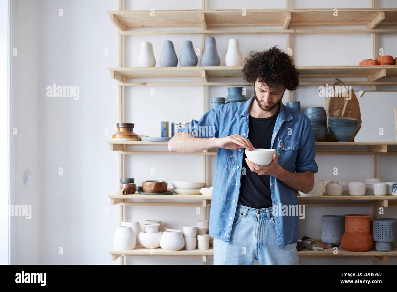Man learning pottery in art studio Stock Photo