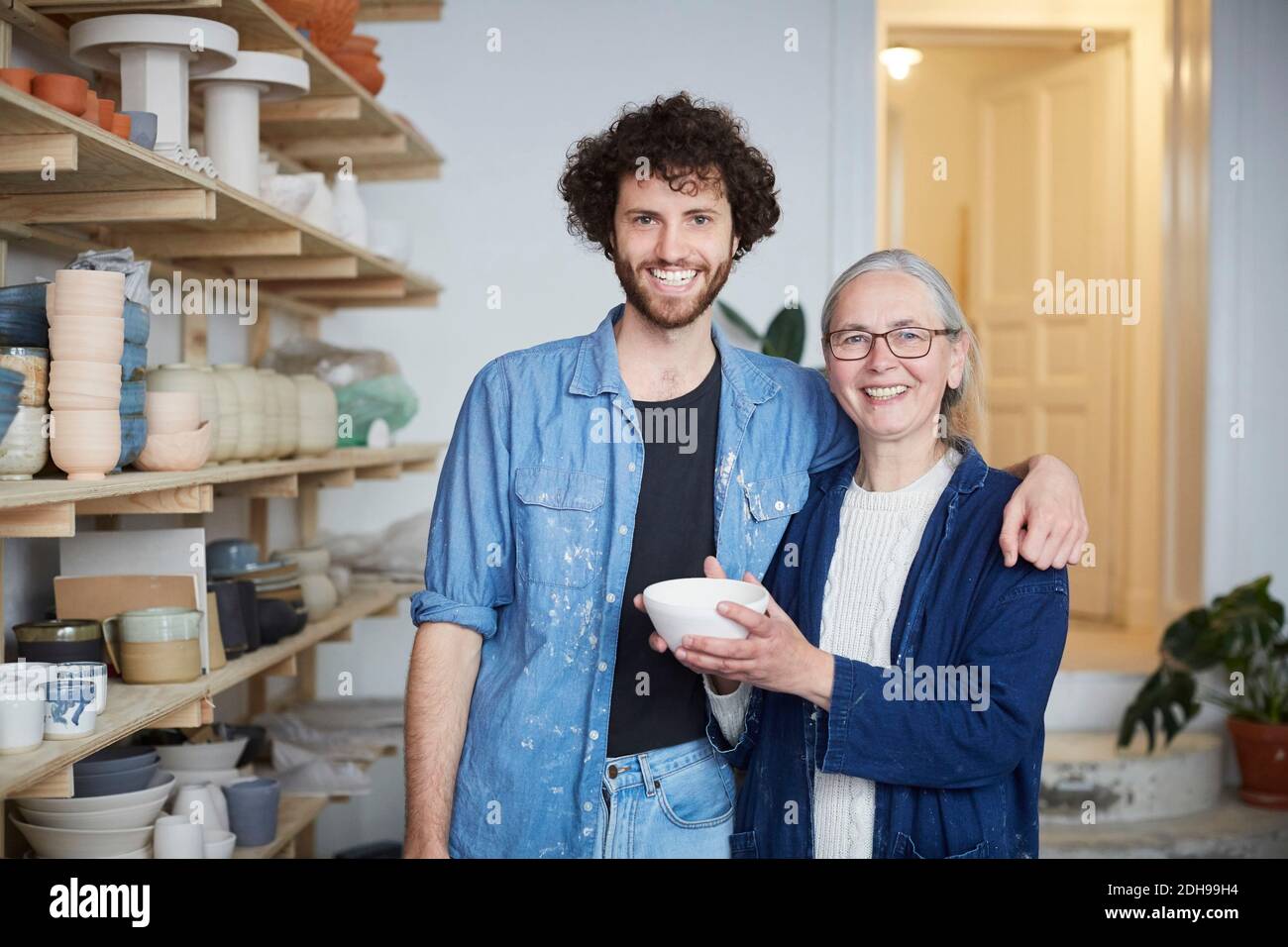 Portrait of smiling man and woman in pottery class Stock Photo