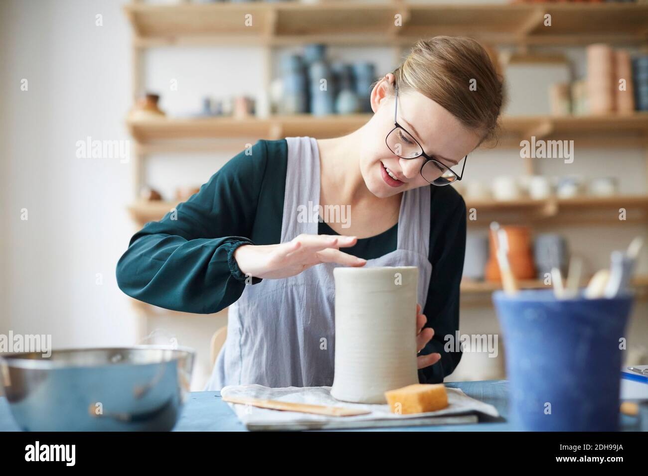 Young woman molding pot in art class Stock Photo
