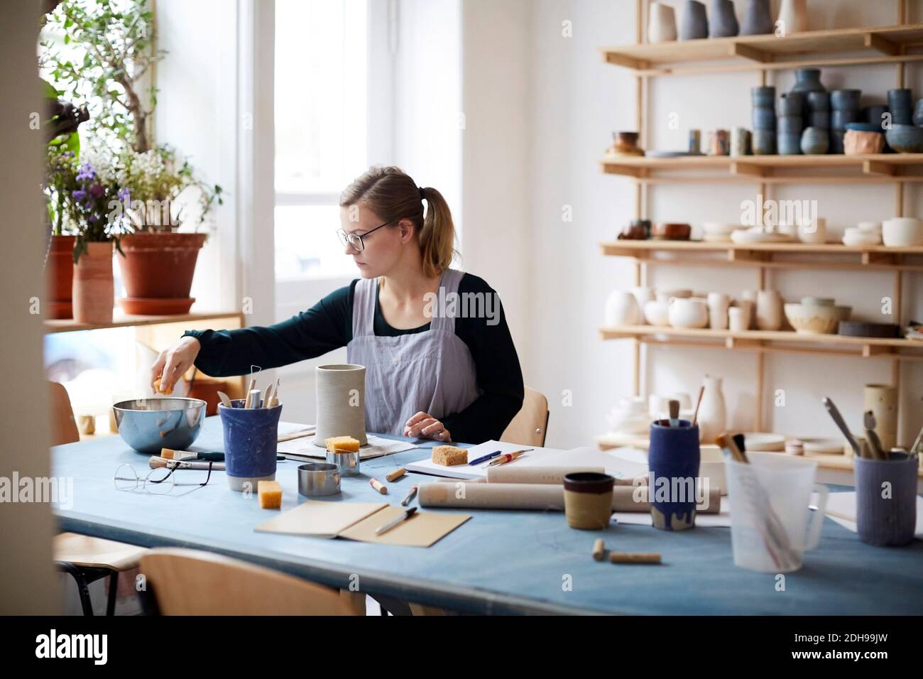 Young woman learning pottery in art class Stock Photo