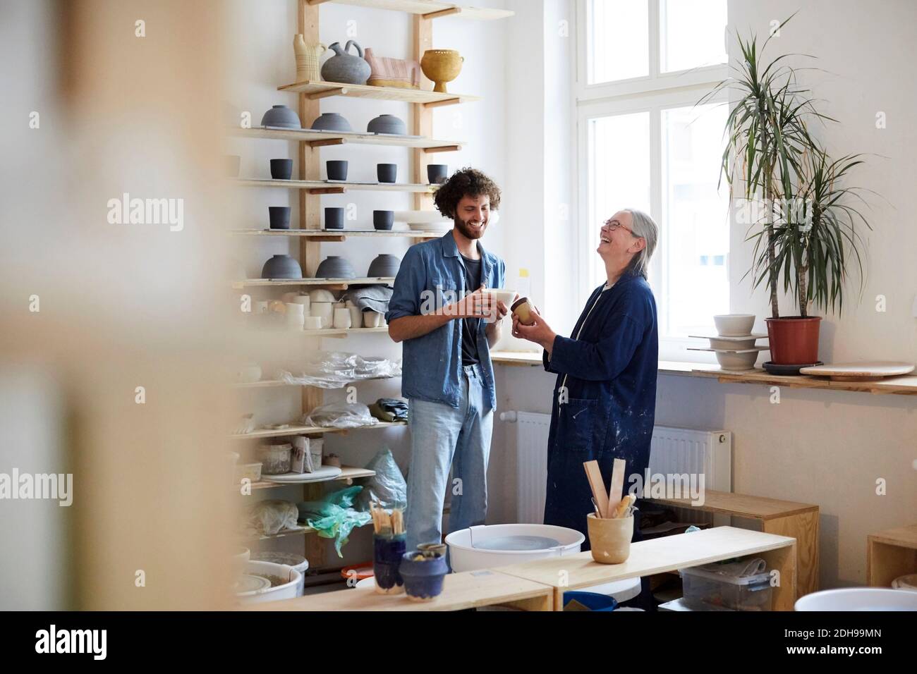 Smiling man and woman in art class Stock Photo