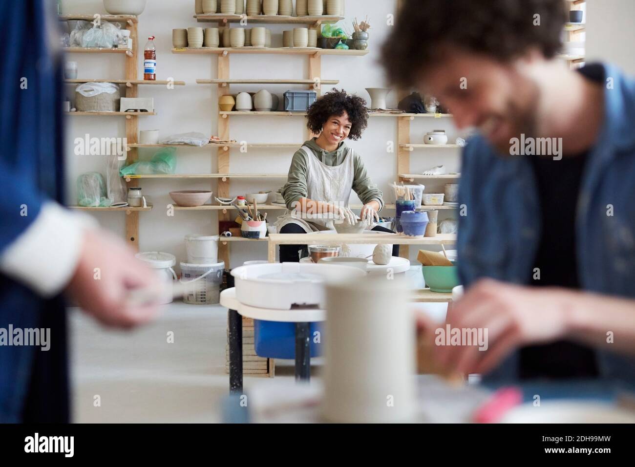 Portrait of smiling woman learning pottery in art class Stock Photo