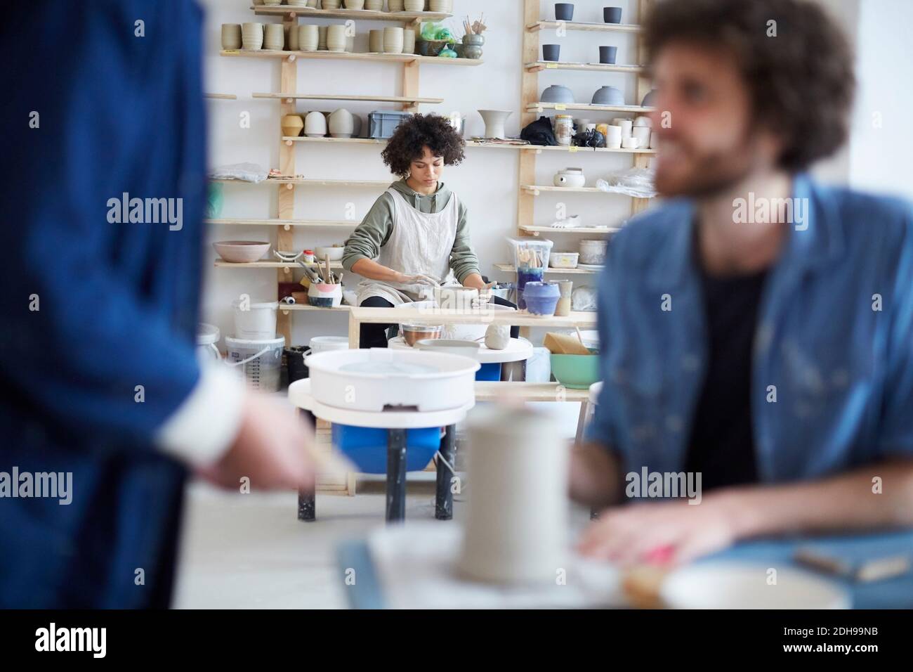 Woman molding clay in pottery class Stock Photo
