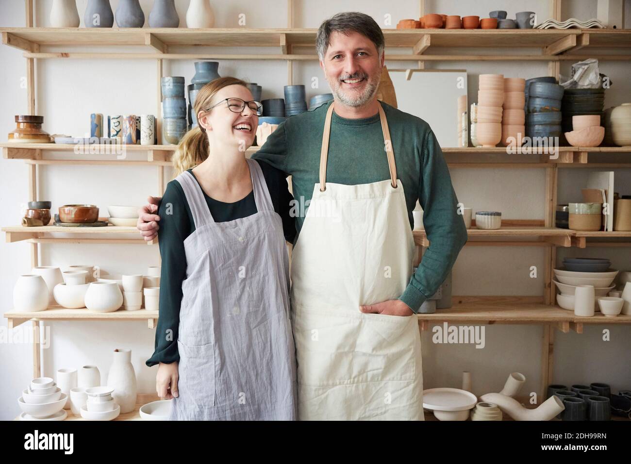 Smiling male and female coworkers in art studio Stock Photo
