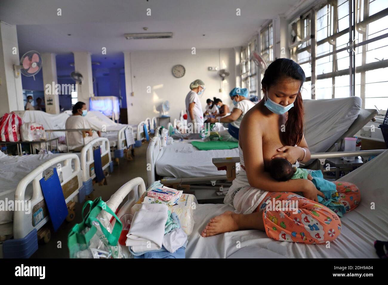 Manila, Philippines. 08th Dec, 2020. A mother is breastfeeding her baby