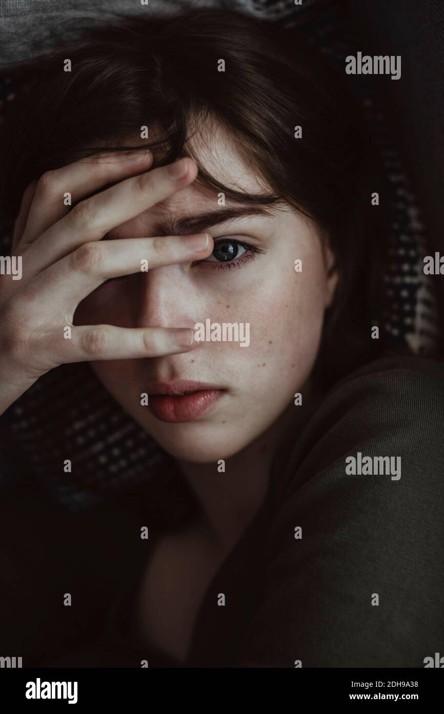 Portrait of stressed woman on sofa Stock Photo
