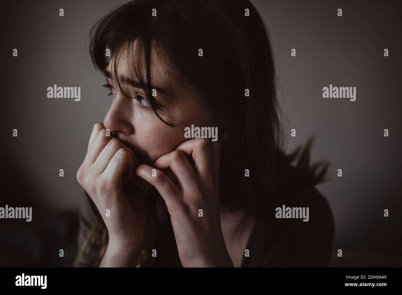 Close-up of worried woman looking away Stock Photo