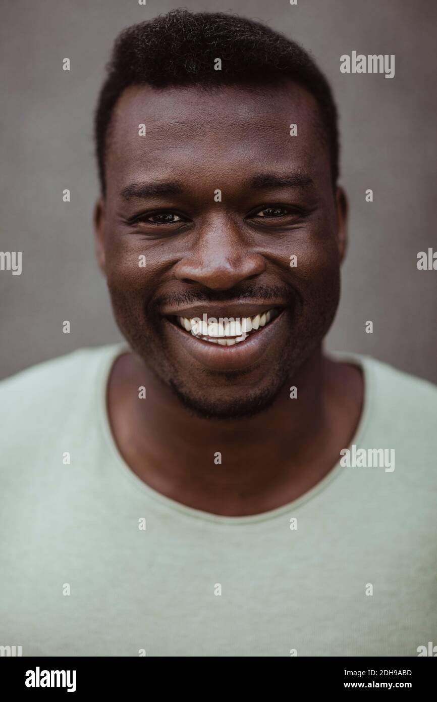 Close-up portrait of happy man standing outdoors Stock Photo