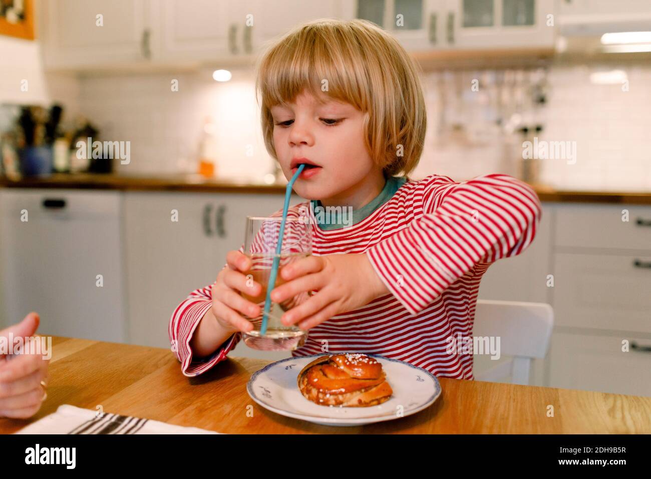 Boy having drink at dining table Stock Photo