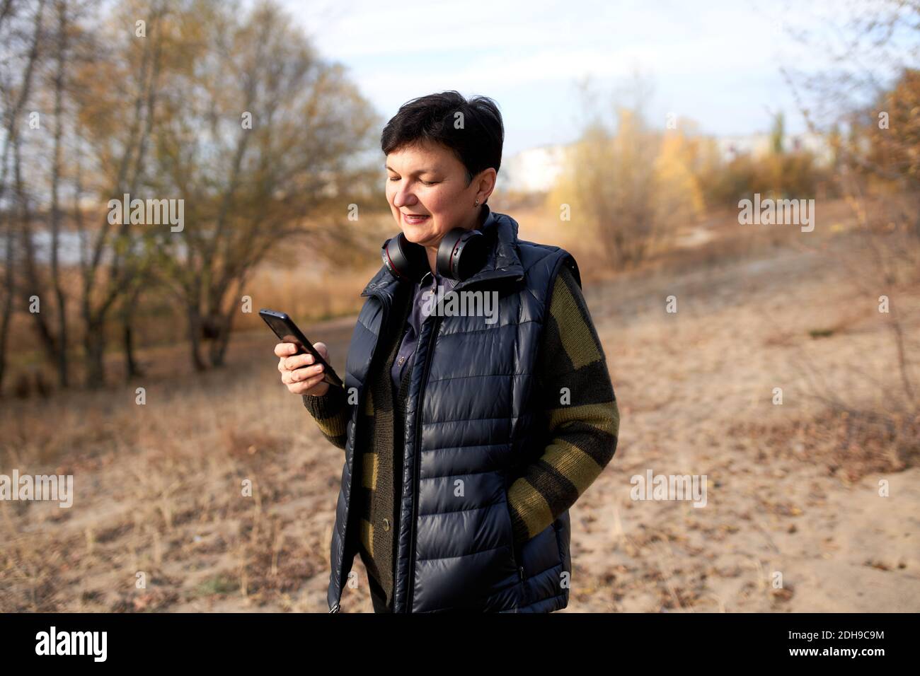 Mature woman walking outdoors hi-res stock photography and images - Alamy