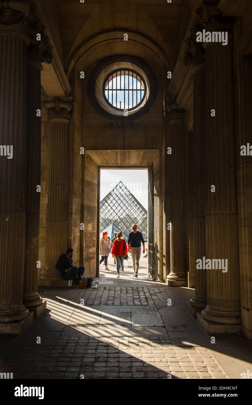 A couple at the Louvre museum yard in Paris, France Stock Photo