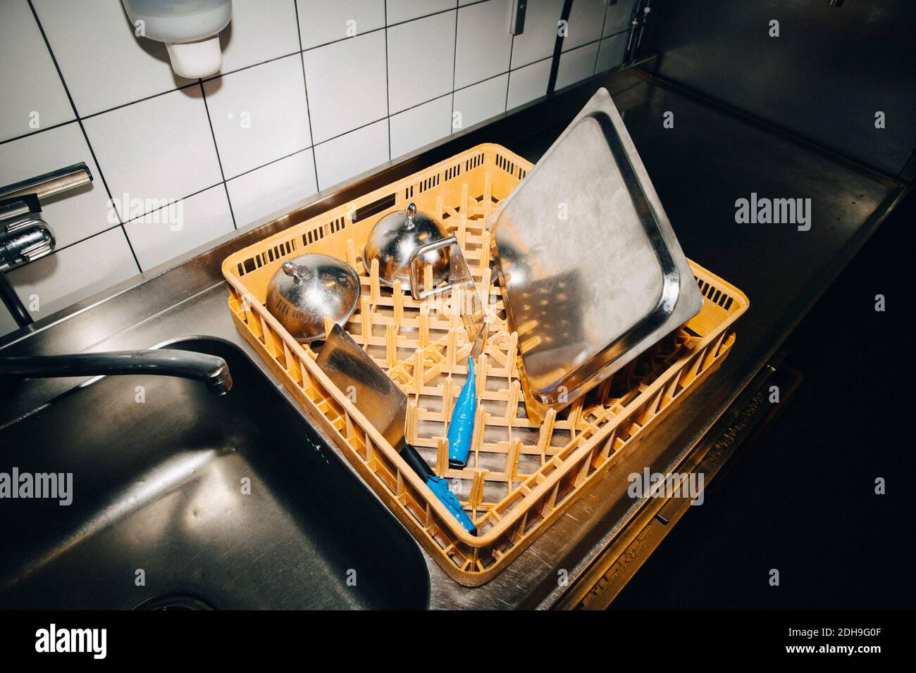 High angle view of basket with kitchen utensils on kitchen counter in cafe Stock Photo