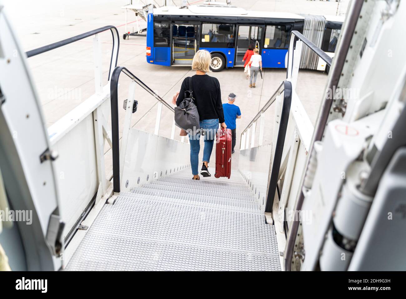 Passengers at the airport with laggage getting off a plane Stock Photo ...