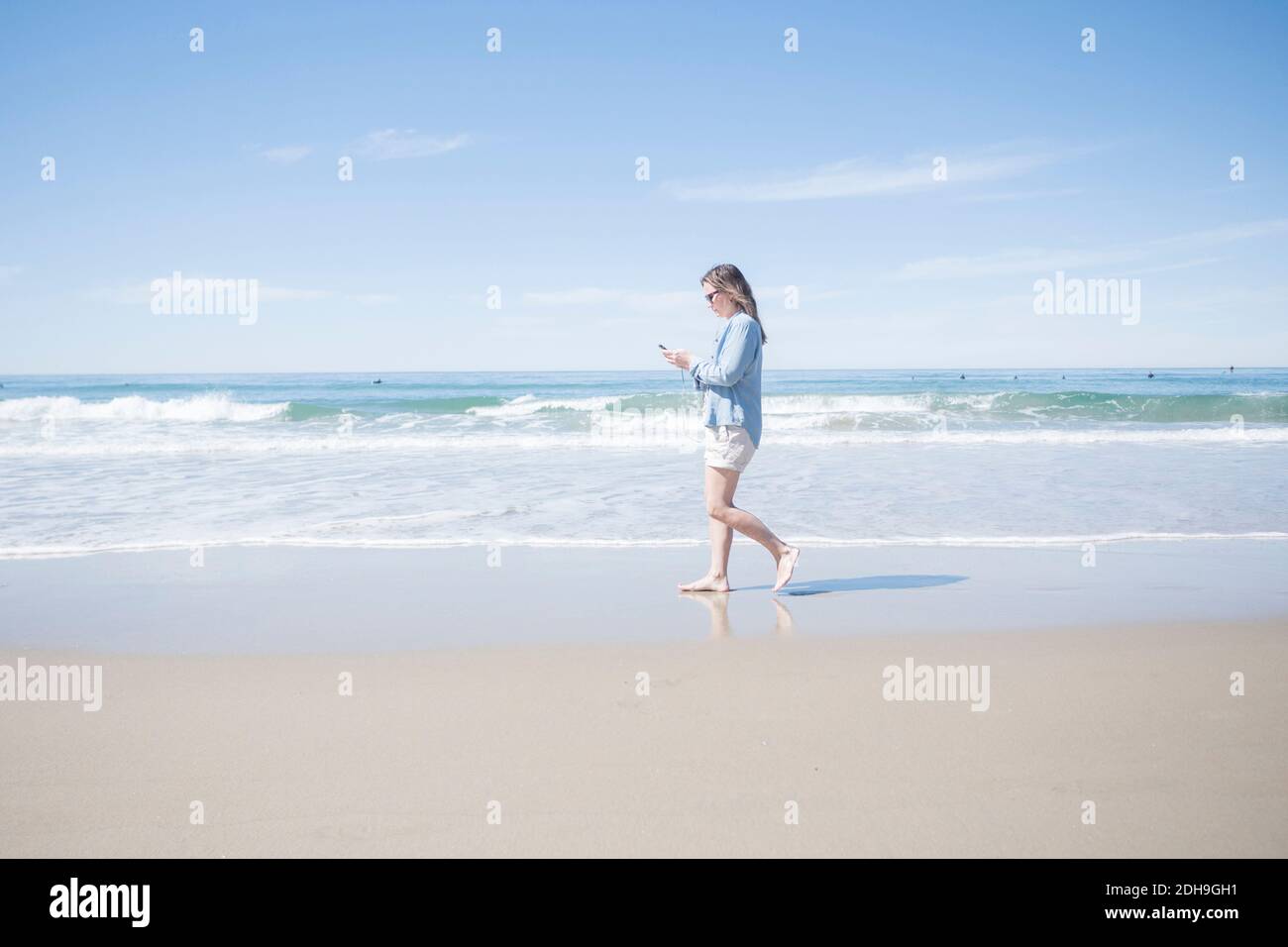 Mature woman walking beach hi-res stock photography and images - Alamy