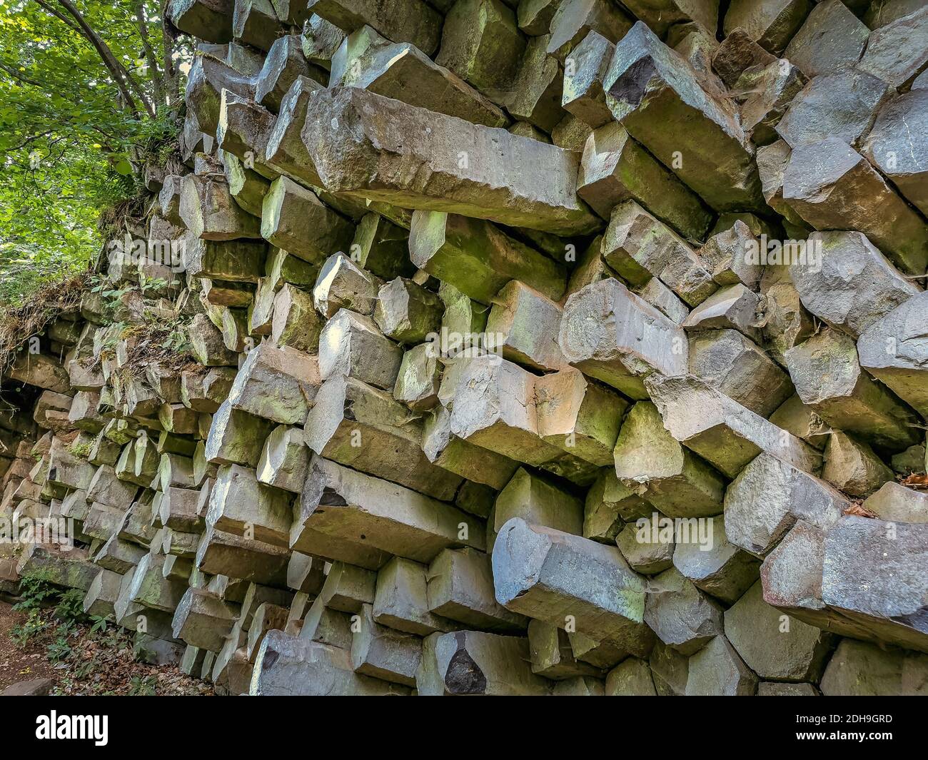 Basalt prism wall at Gangolfsberg consists of wooden stacked basalt columns with a diameter of 30 to 40 cm, Oberelsbach, county Rhön-Grabfeld, Bavaria Stock Photo