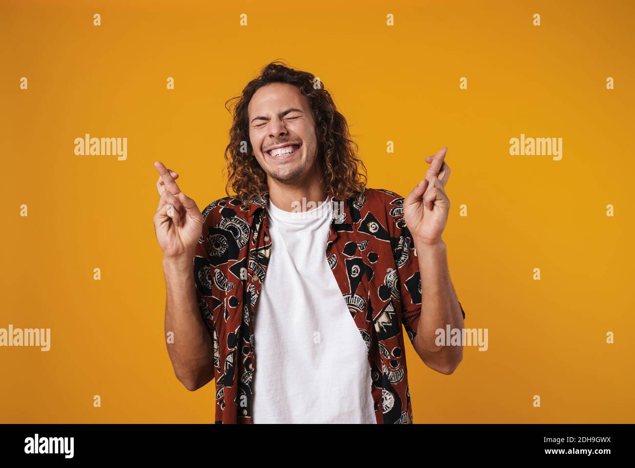 Am Using Guy Photo of amusing handsome guy grimacing and holding fingers crossed ...