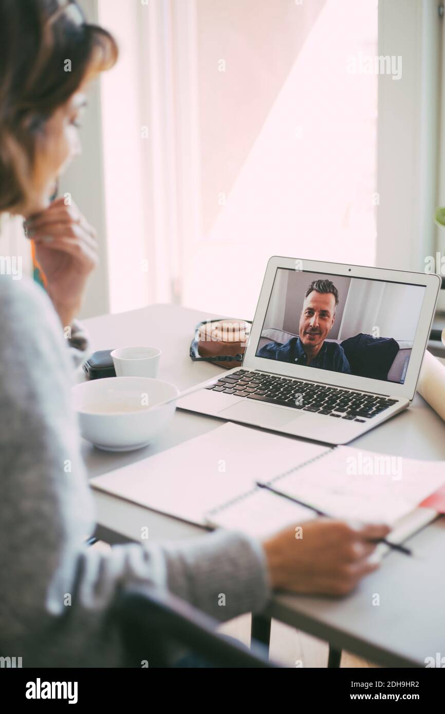 Coworkers having an online meeting at home Stock Photo