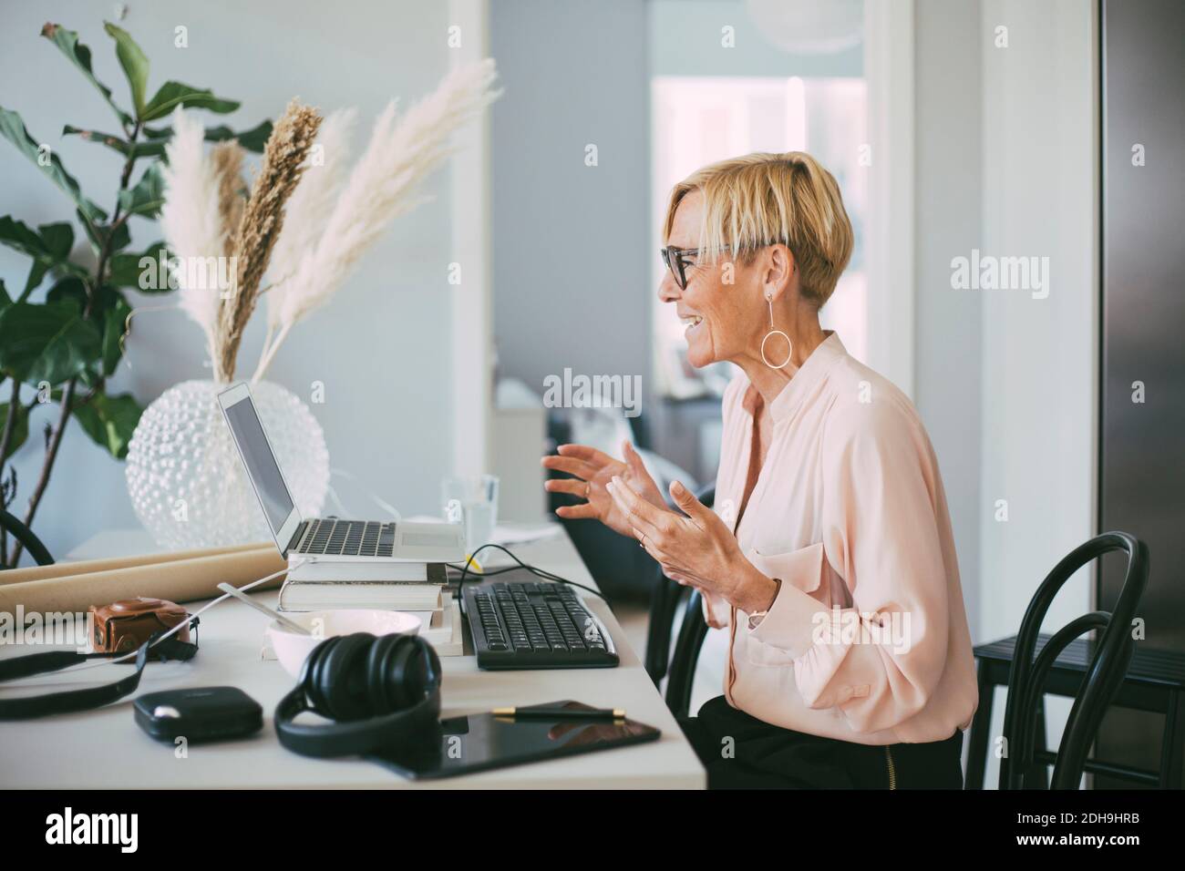 Profile of woman attending video conference at home Stock Photo