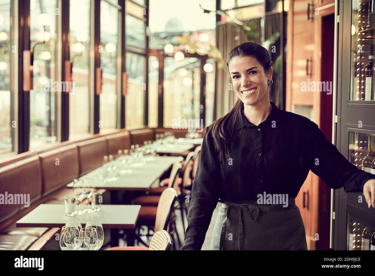 Smiling cafe owner in apron hi-res stock photography and images - Alamy