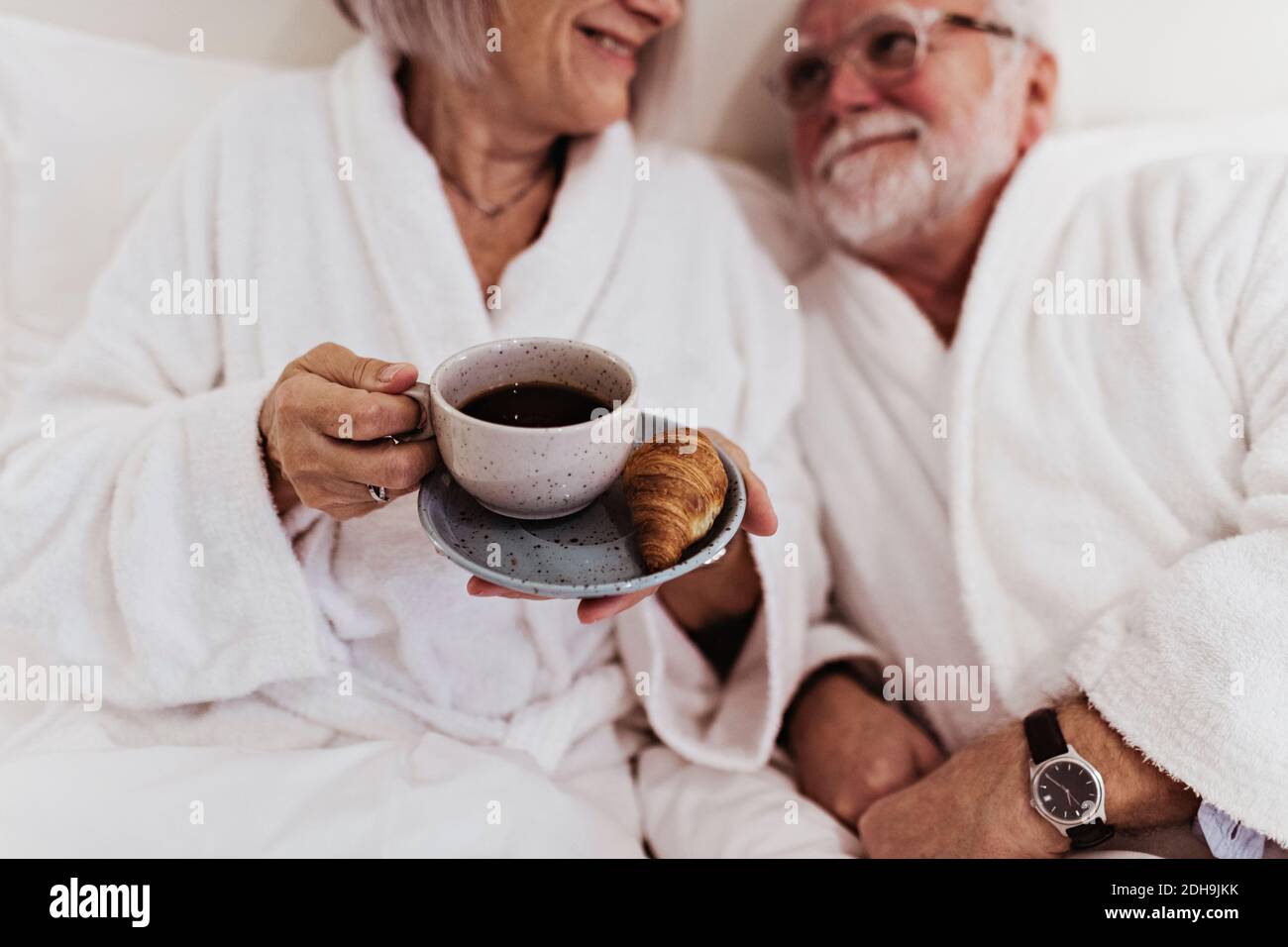 A Woman Sits On The Bed Beside A Face-down Man Coffee Mug by