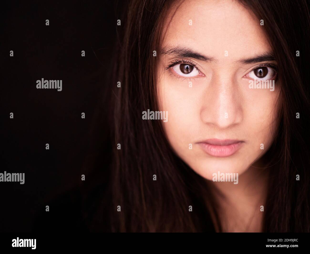 Beautiful young Nepalese woman looking at camera Stock Photo