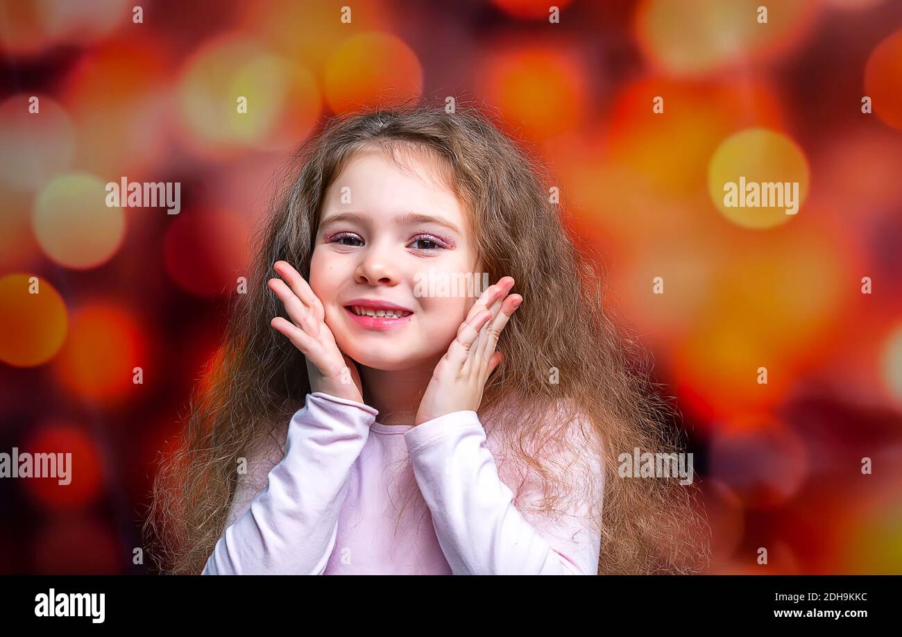 Portrait of happy smiling child girl on colored background. Laughing people. Stock Photo