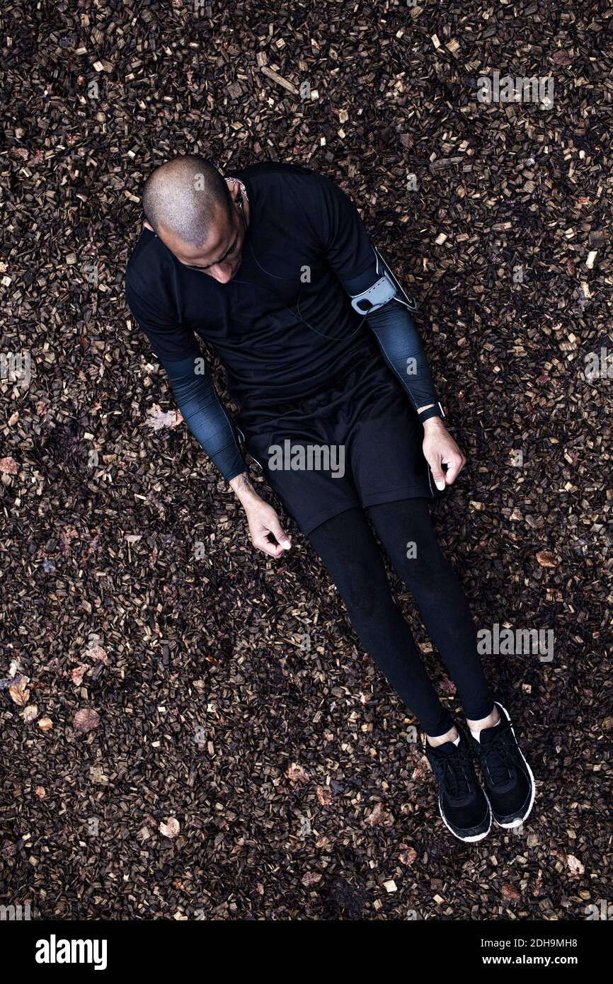 Directly above shot mid adult man exercising in forest Stock Photo
