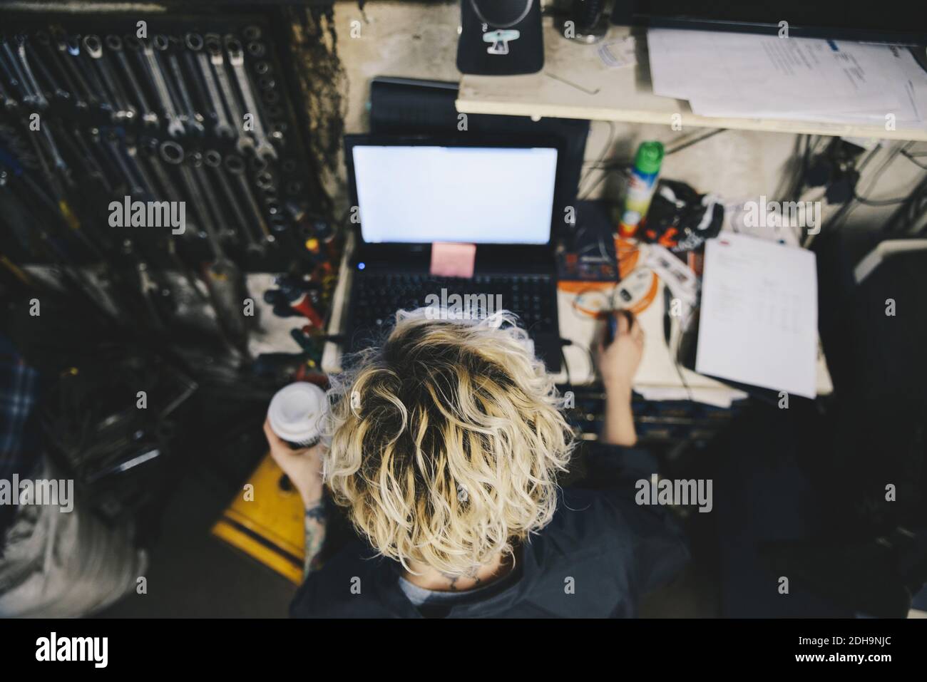 High angle view of female mechanic using laptop at auto repair shop Stock Photo