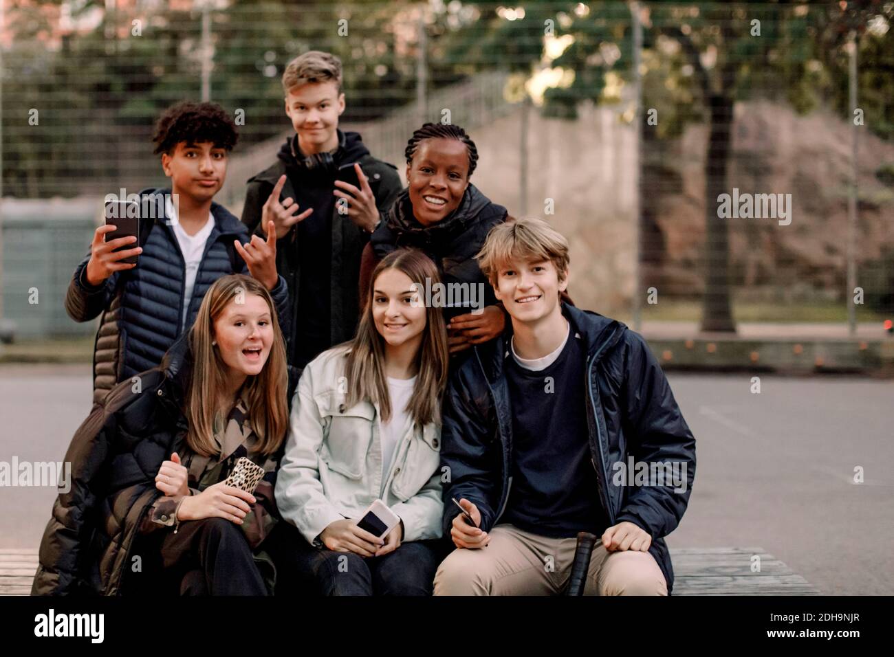 Portrait of smiling multi-ethnic male and female teenage friends at ...
