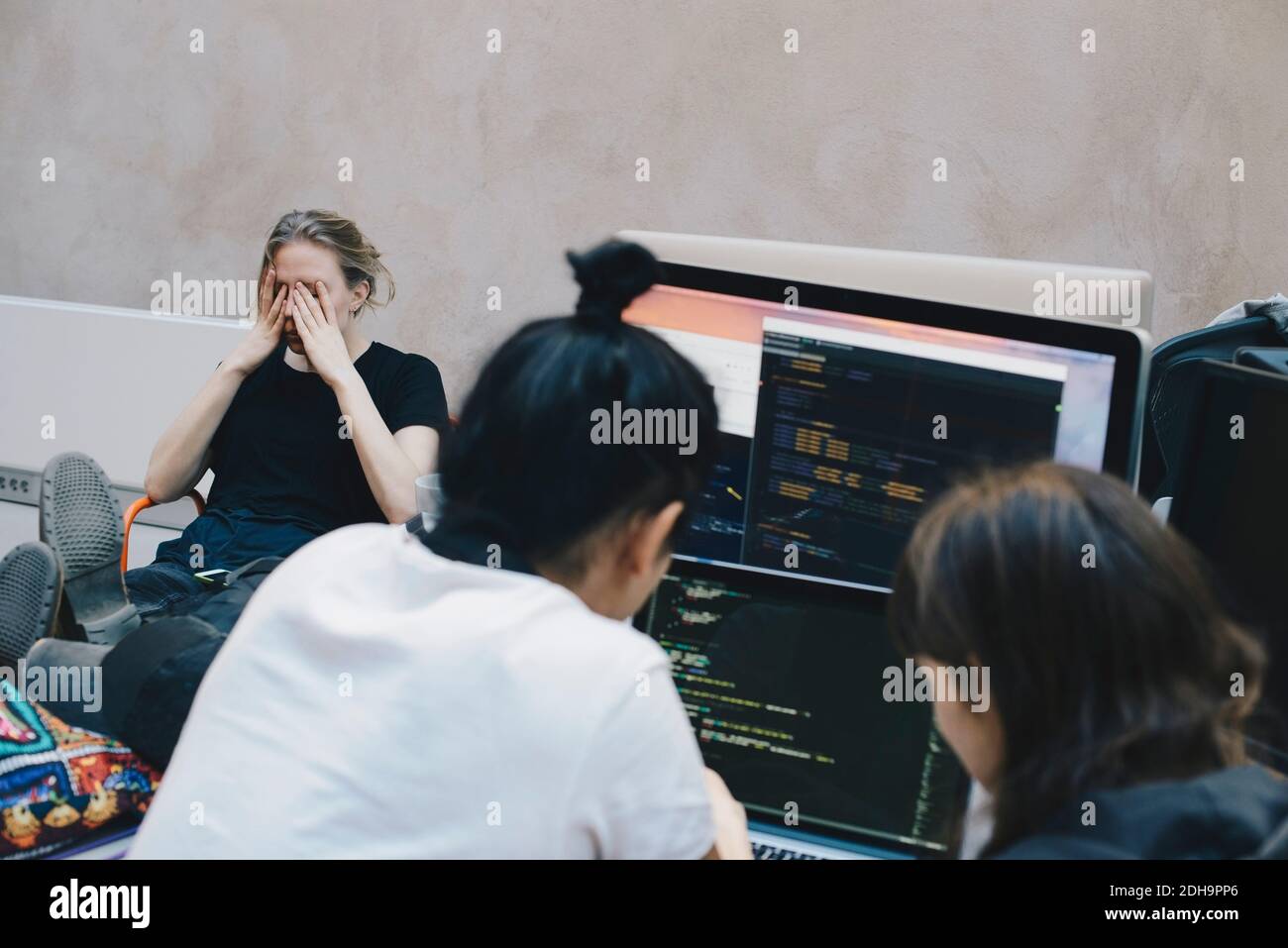 Male and female computer programmers using computer at office Stock ...