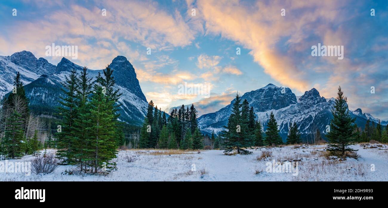 Beautiful nature scenery at dusk in winter season. Sky of pink clouds, Snow capped Mountains Mount Rundle and Mount Lawrence Grassi Ha Ling Peak Stock Photo
