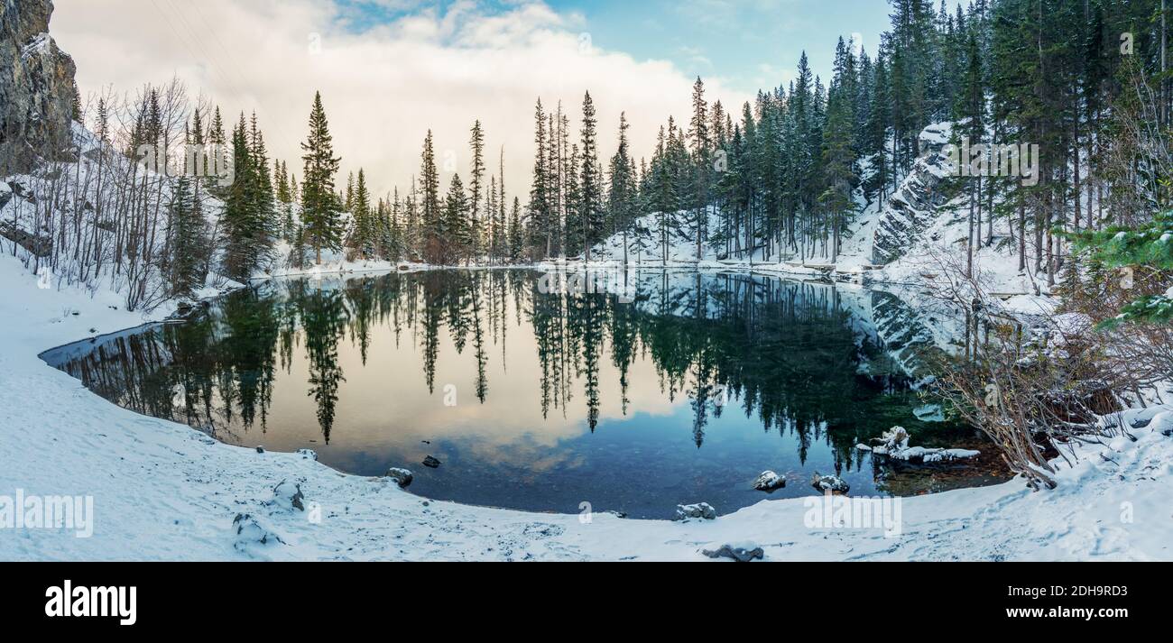 Upper Grassi Lakes in winter season. The reflection of the lake surface like a mirror. Canmore, Alberta, Canada. Stock Photo