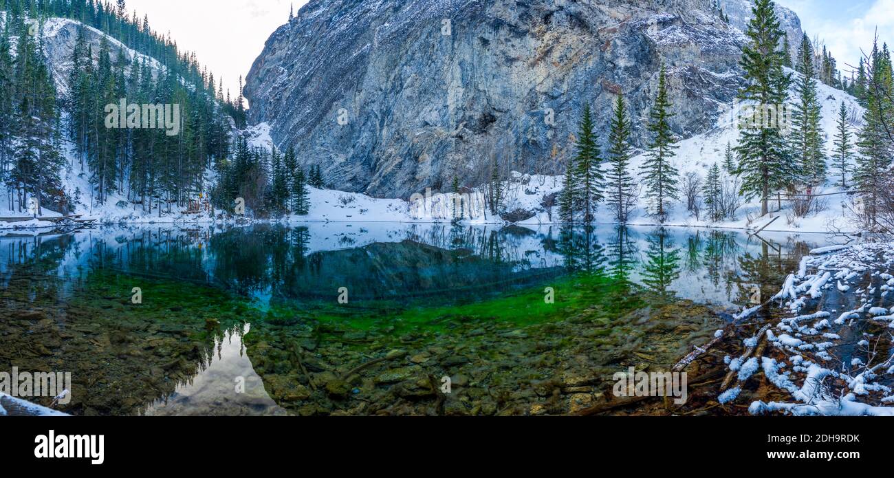 Panorama view of Upper Grassi Lakes in winter season. The reflection of the lake surface like a mirror. Canmore, Alberta, Canada. Stock Photo