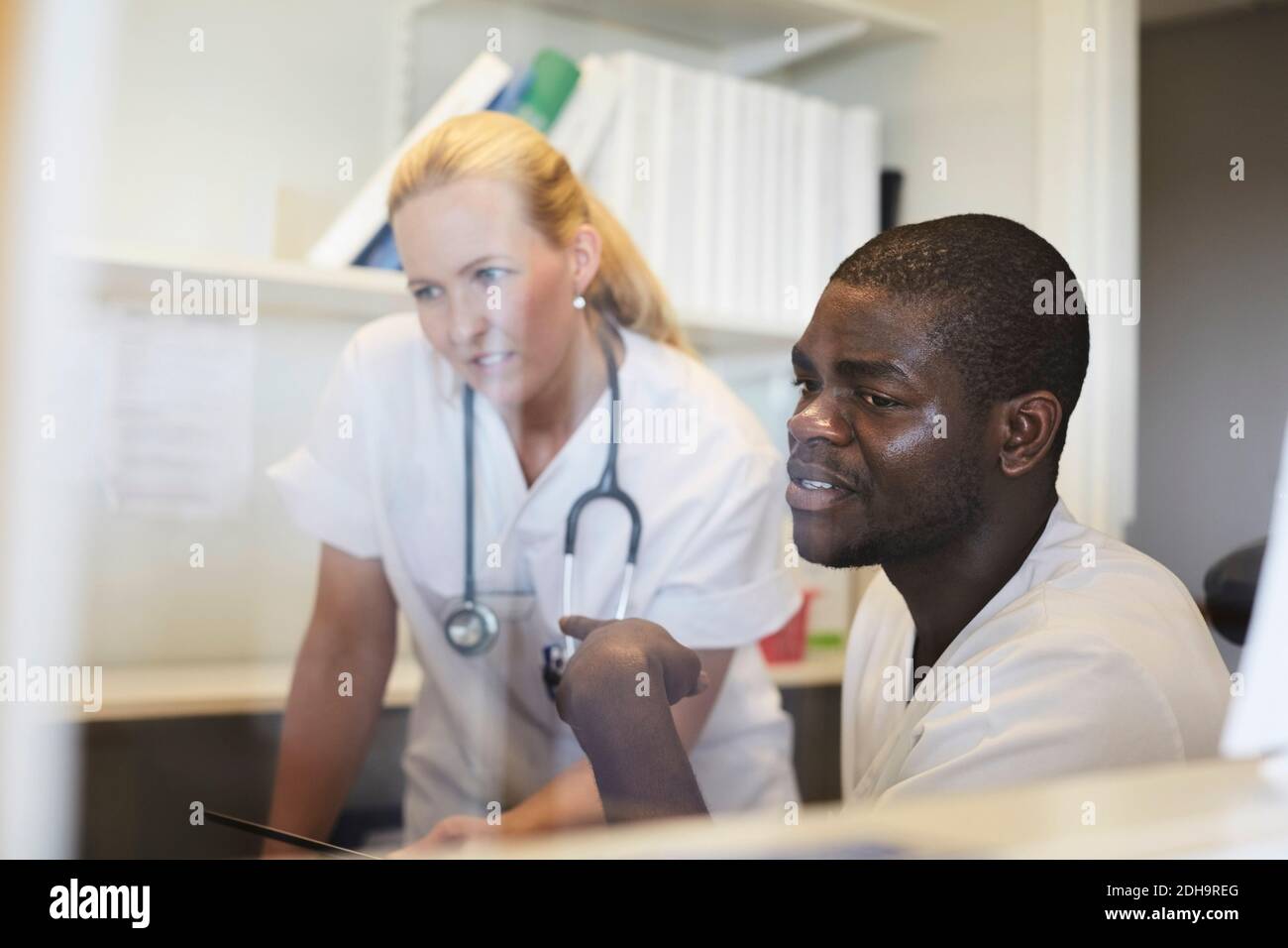 Male and female nurses working in hospital office Stock Photo