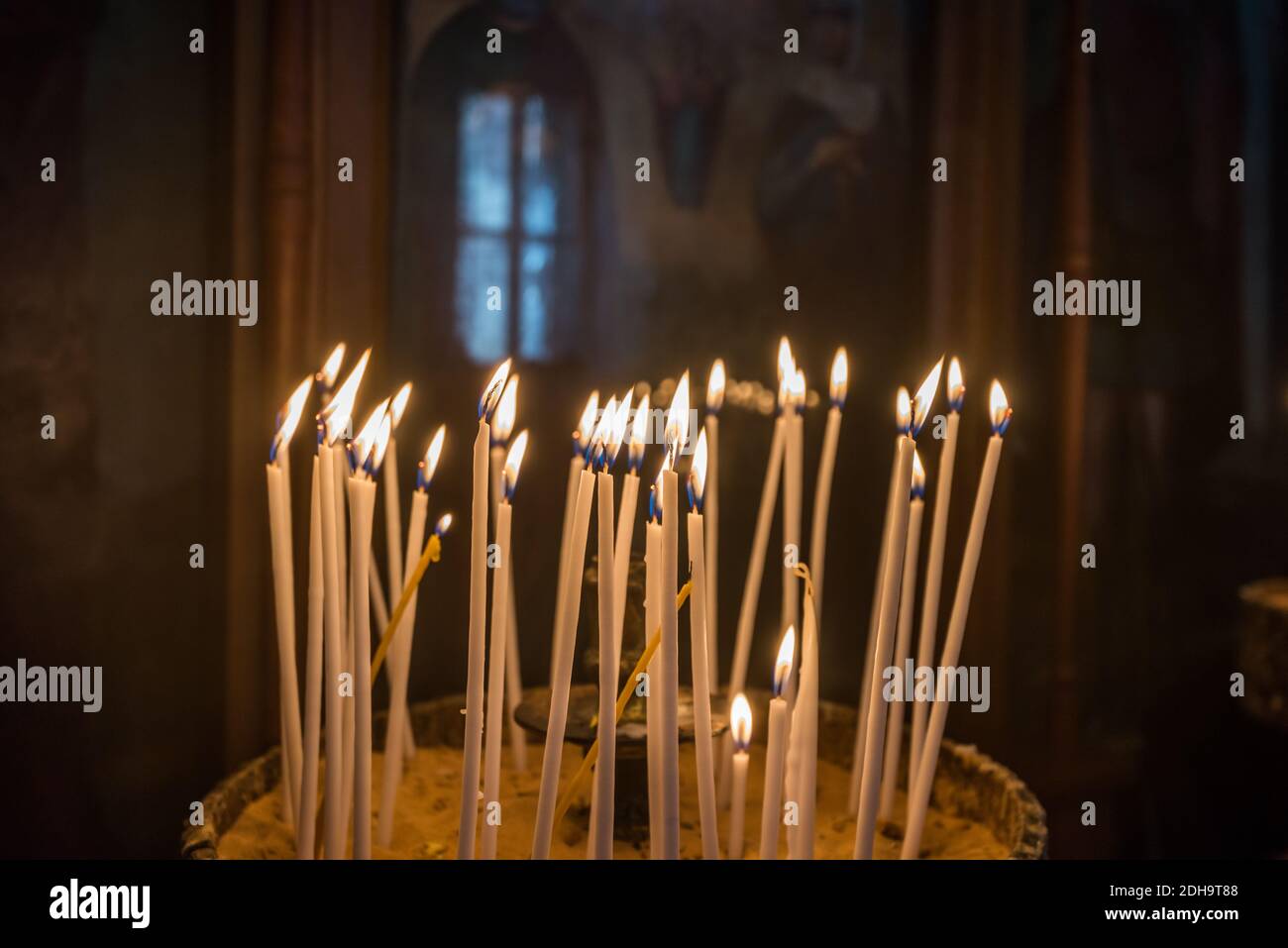 Woman lighting candle in orthodox hires stock photography and images