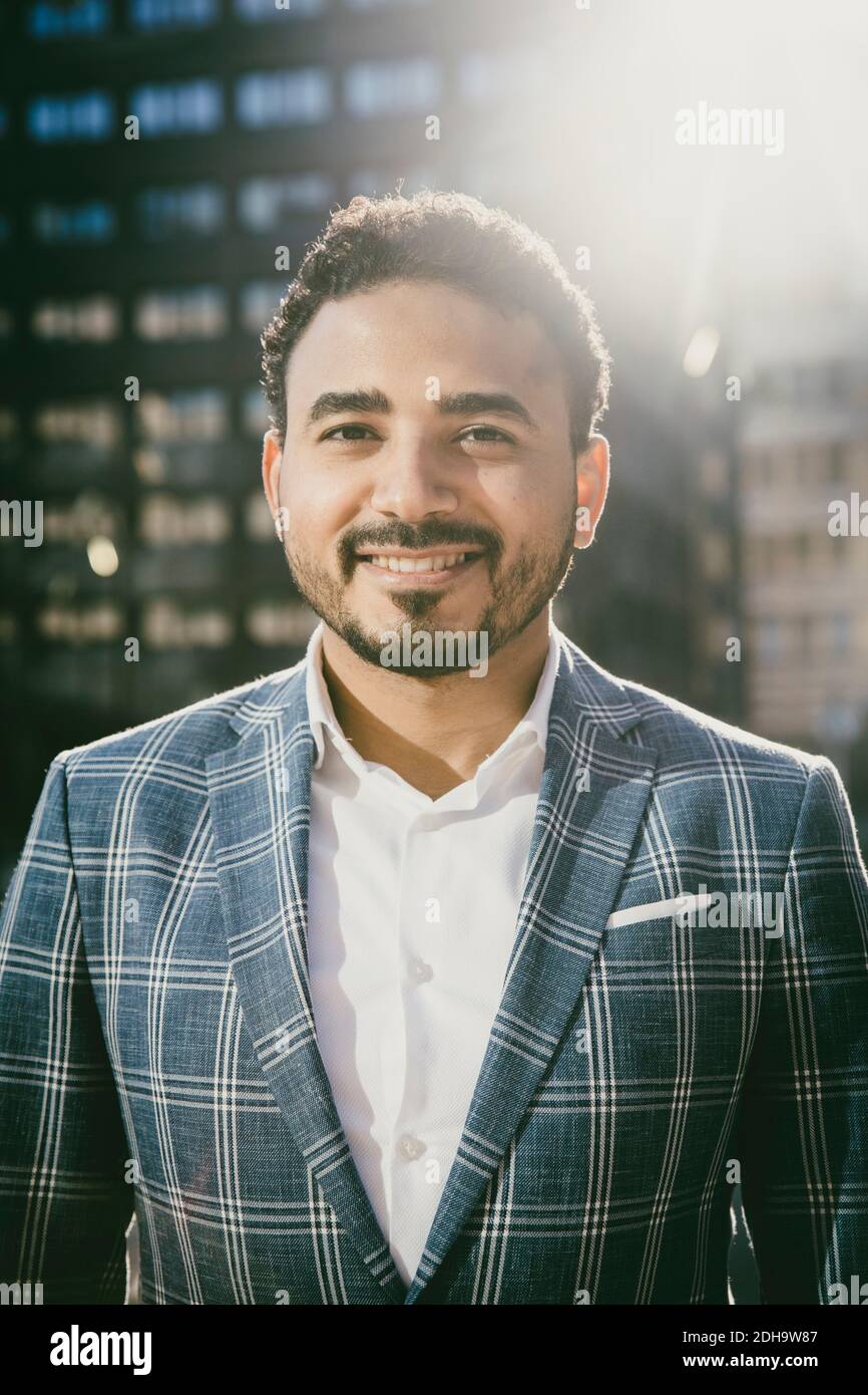 Portrait of businessman standing outside office building Stock Photo ...